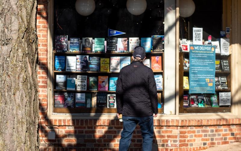 a person walking in front of a storefront