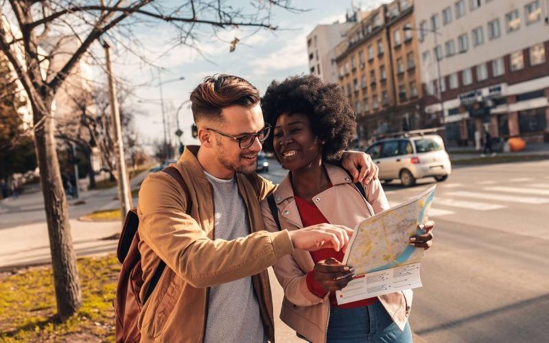Close to the center of everything a man and woman looking at a map in the city