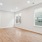 a room with a wood floor and windows
